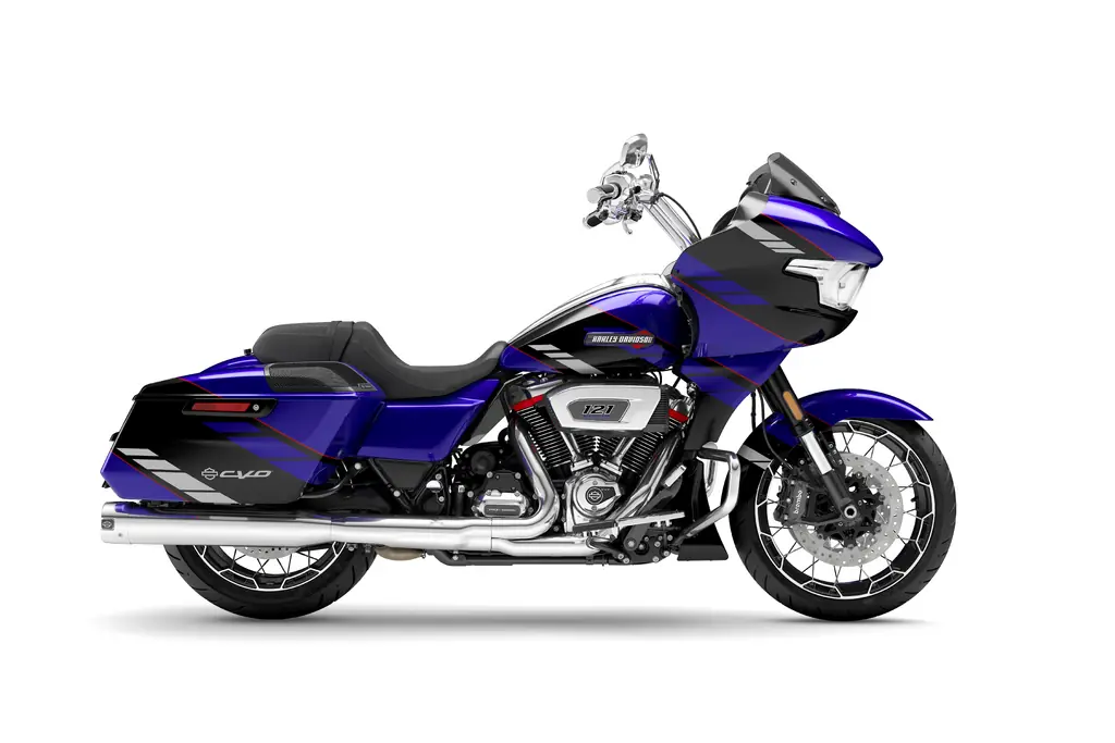 Right-side studio view of a blue-purple 2025 Harley-Davidson CVO Road Glide with black and silver graphics, chrome exhaust and hard saddlebags.