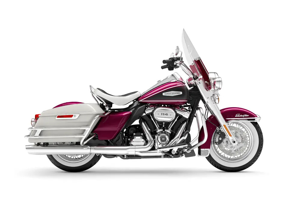 Right-side studio view of a magenta and white 2023 Harley-Davidson Electra Glide Highway King with a white solo seat, whitewall tyres and tall windscreen.