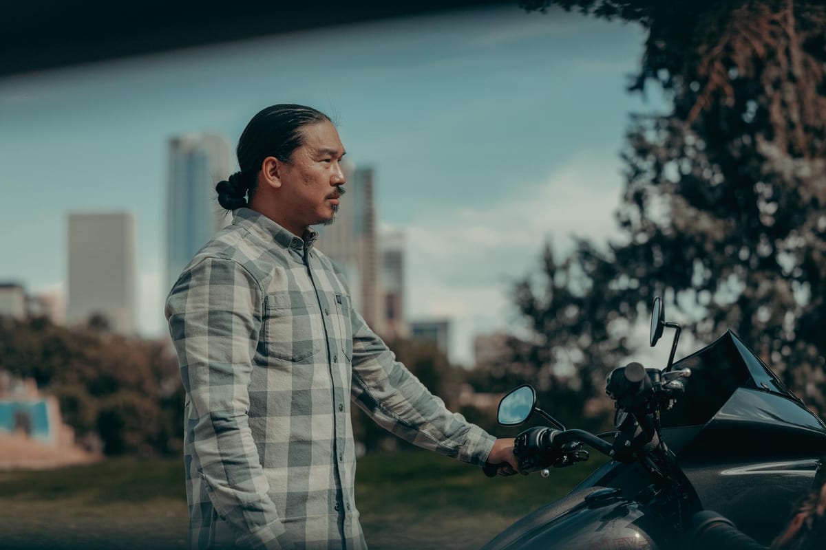 A rider standing beside a Harley-Davidson Low Rider ST